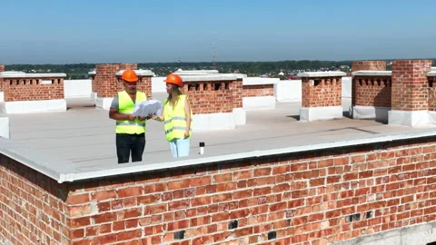 Aerial view Two builders architects, a man and a woman, inspect the construction Video stock 212579695