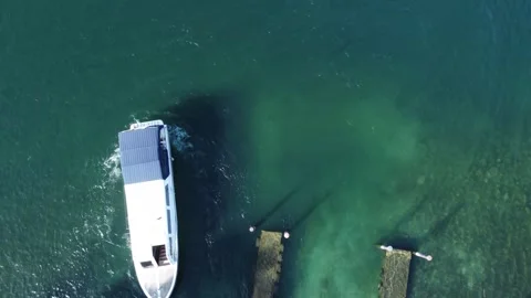 Aerial view of two cargo ships meeting in the ocean near an island Stock Footage 252934430