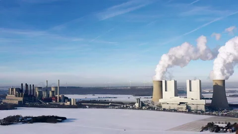 Aerial view of two coal-fired power plants in a wintry landscape in Germany Video stock 263158214
