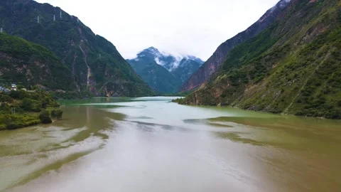 Aerial view of two color river bay tidal flat gentle green mountain valley Stock Footage 337926754