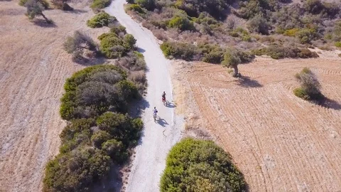 Aerial view two cyclists tourists rides on old asphalt road by bicycle, Cyprus Vídeos de archivo 109899982
