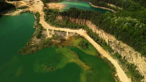 Aerial View of Two Forest Lakes with Sandy Trails and Visible Cliffs This aerial Stock Footage 277357952