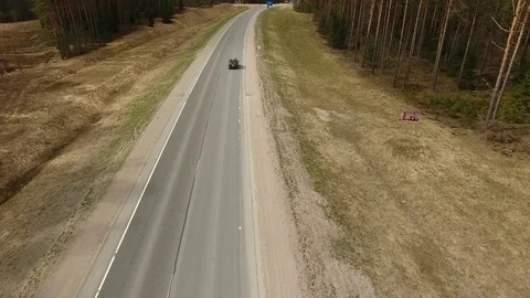 Aerial view of two-lane forest road with cars trucks moving Video stock 84499800