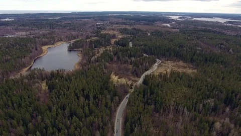 Aerial view of two-lane forest road with cars trucks moving Video stock 84500394