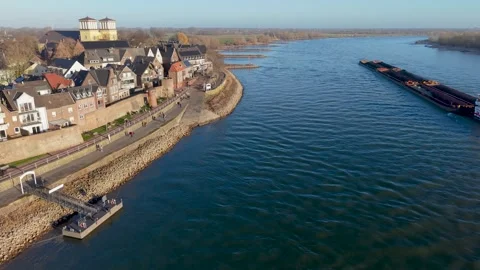 Aerial view of two large cargo ships navigating a wide river with grassy banks 動画素材 332739764