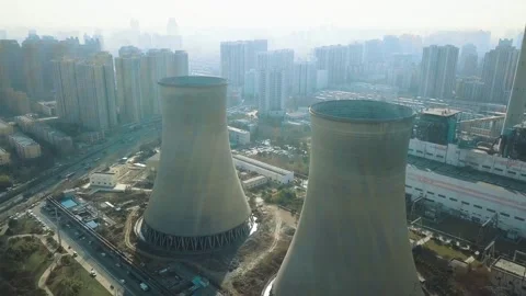 Aerial View of Two Large Cooling Towers Near Urban City 库存影片 334705087