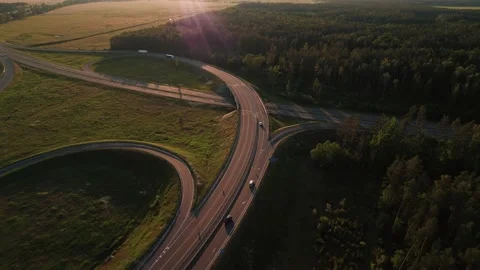Aerial view of a two-level suburban road junction surrounded by green meadows Stock-Footage 222010114