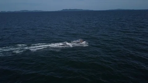 Aerial View of two men riding Jet Ski in Bangkok sea Stock Footage 122829914