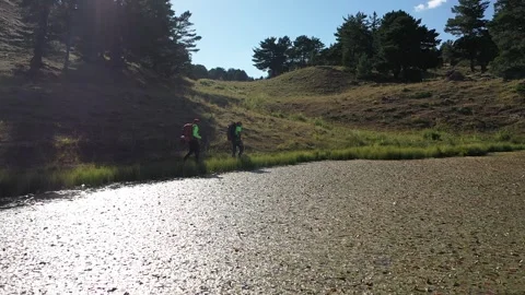 Aerial view of two men walking by the lake 3 Stock Footage 294092979