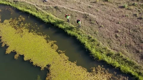 Aerial view of two men walking by the lake 2 Stock Footage 294093208