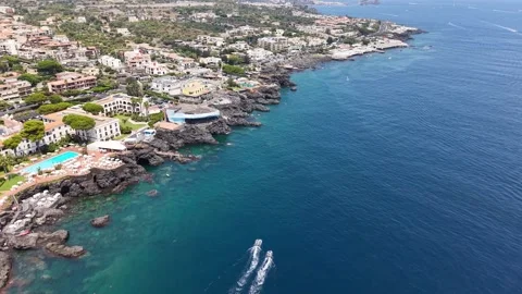 Aerial view of two motorboats navigating blue waters along a rocky coastline Stock-Footage 345038018