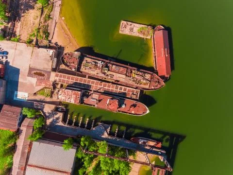 Aerial view, two old, rusty barges, moored at the pier on river 스톡 사진
