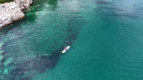 Aerial View of Two People Sharing a Paddleboard Stockbeeldmateriaal 340508075