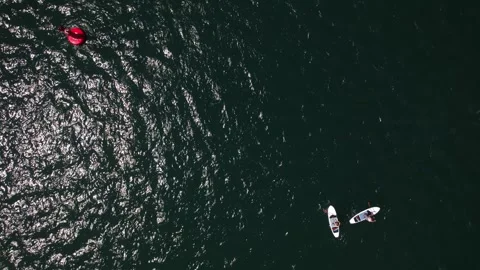 Aerial View of Two People Stand Up Paddle Boarding in rough seas  Stock Footage 277906608