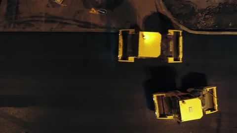 Aerial view, two road rollers are laying asphalt. Loading asphalt mix from a Stock-Footage 154211790