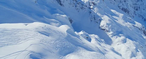 Aerial view of Two skiers standing on a mountain slope in the Swiss Alps.  Stock Footage 121478331