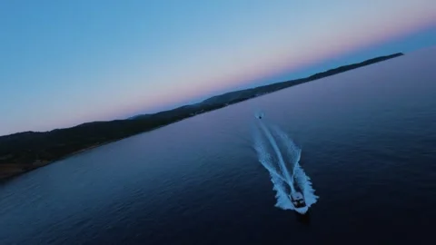Aerial view of two small boats returning to harbor at sunset Stock Footage 328192558