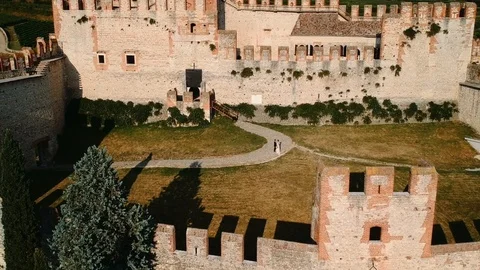 Aerial view of two spouses in the courtyard of an ancient castle. Stock Footage 100236437