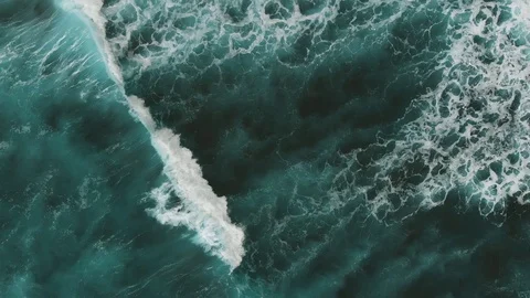 Aerial view. Two surfers trying to swim on the spot through the giant turquoise Stock Footage 112033036