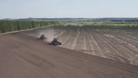 Aerial view of Two tractors going in opposite direction and cultivating land Stock Footage 106266023