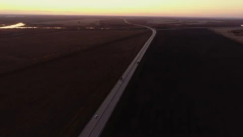 Aerial view. Two trucks are driving along the highway. Two way road at sunset Stock-Footage 201690388