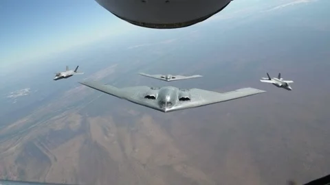 Aerial view of two U.S. Air Force B-2 Spirit aircraft flying with two RAAF F-35A Stock-Footage 201928228