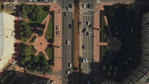 Aerial view of a two-way road section circling the height of storied houses Stock Footage 112390611
