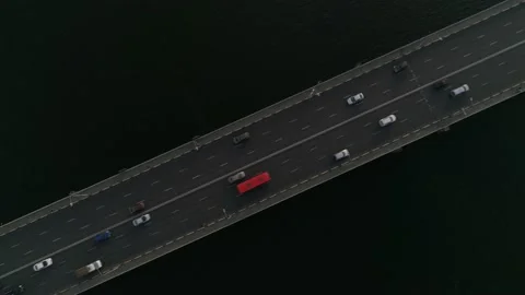 Aerial view. Two-way traffic on the bridge over river. Cars ride on overpass. 스톡 동영상 140119892