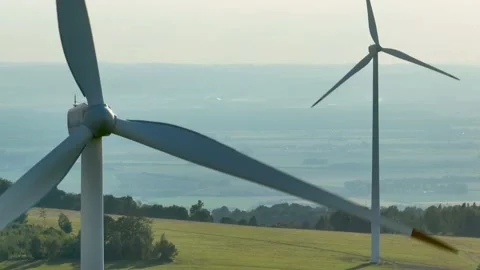 Aerial view of two Wind turbines in full operation against landscape. 動画素材 233835655