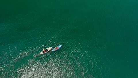 Aerial view of two women paddling on paddle board Video stock 90851753