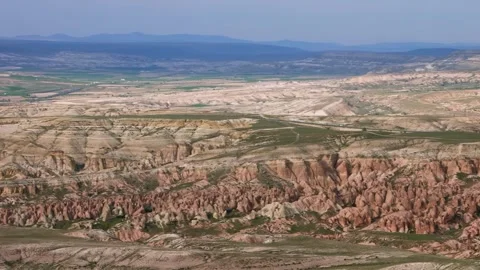 Aerial View of the Unique Rock Formations and Rugged Landscape of Cappadocia, Tu Stock Footage 332545740