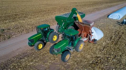 Aerial view of unloading corn grain into tractor trailer after harvest in field. Foto stock