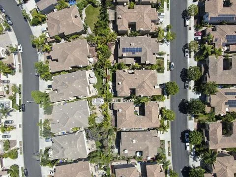 Aerial view of upper middle class neighborhood with residential houses in green Stock Photos