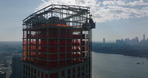 Aerial view of upper section of high rise building under construction against 動画素材 167686476