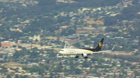 Aerial view of UPS cargo plane flying into San Francisco Video stock 64796174