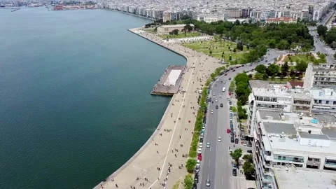 Aerial view of urban coast, park with people, road with cars Stock Footage 130378853