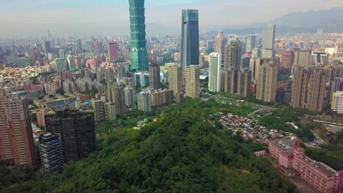 Aerial View of Urban Forest Surrounded by High Rise Buildings Taiwan 4K Stock Footage 346050017