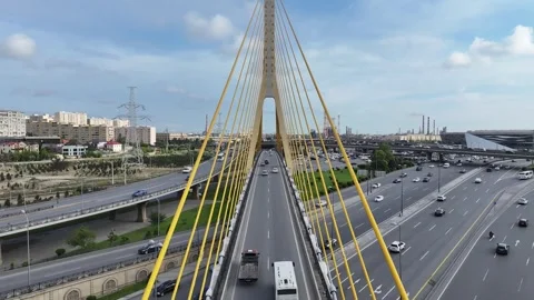 Aerial View of Urban Highway System with Cable-Stayed Bridge and Traffic Stock Footage 341969320