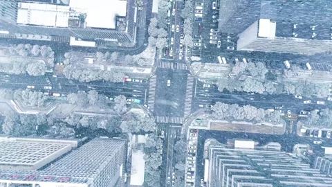 Aerial View of Urban Intersection During Heavy Snowfall in Winter City Stock Footage 347056865