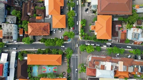 Aerial View of Urban Intersection with Red-Tiled Roofs in Bali, Indonesia Stock Footage 314988455
