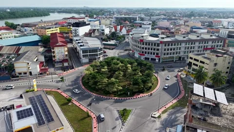 Aerial view of urban roundabout with greenery and surrounding buildings Stock Footage 337669016