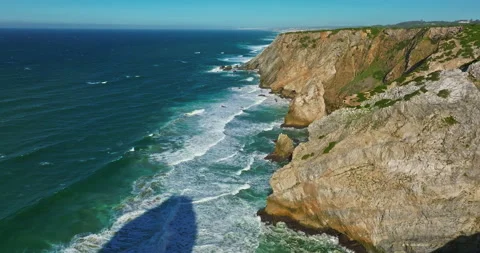 Aerial view Ursa beach Atlantic coastal surf with foamy waves crashing over big Vídeo Stock 311117615
