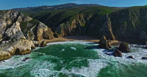 Aerial view Ursa beach Atlantic coastal surf with foamy waves crashing over big 動画素材 311496001