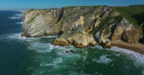 Aerial view Ursa beach Atlantic coastal surf with foamy waves crashing over big Video stock 311498647