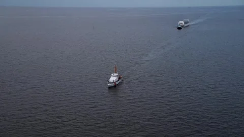Aerial view USCG piloting NASA's Pegasus Barge ferrying Artemis II Rocket Stage Stock Footage 281241583