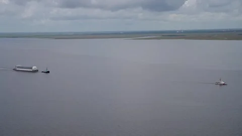 Aerial view USCG piloting NASA's Pegasus Barge ferrying Artemis II Rocket Stage Stock Footage 281241722