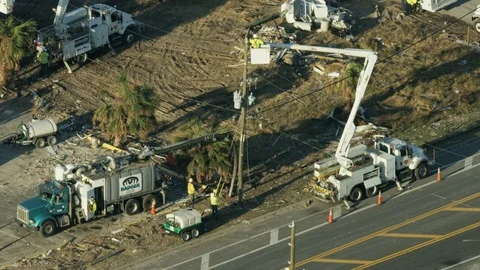 Aerial view utility workers repairing infrastructure after Hurricane Stock Footage
