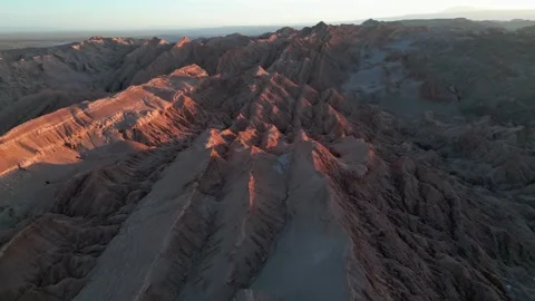 Aerial view of Valle de la Luna sharp eroded rock ridges with warm sunset glow Stockbeeldmateriaal 335216640