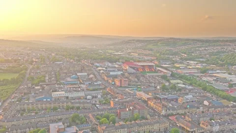 Aerial view of Valley Parade Stadium and Bradford cityscape at sunset Stock Footage 337637017