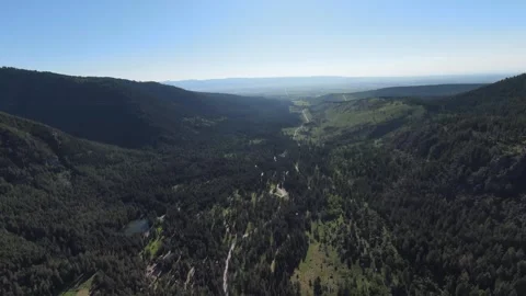 Aerial view of a valley split open by a path in the middle Stock Footage 303455394